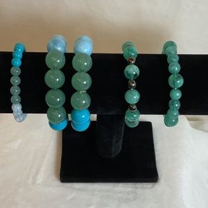 Elastic stretch bracelets. Set of five. All in soft blue/blue green tones.